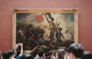 Two Activists Detained for Placing Posters Around "Liberty Leading The People" Painting at Louvre